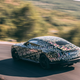 A photo of the rear of a camouflage Rolls Royce Spectre EV.
